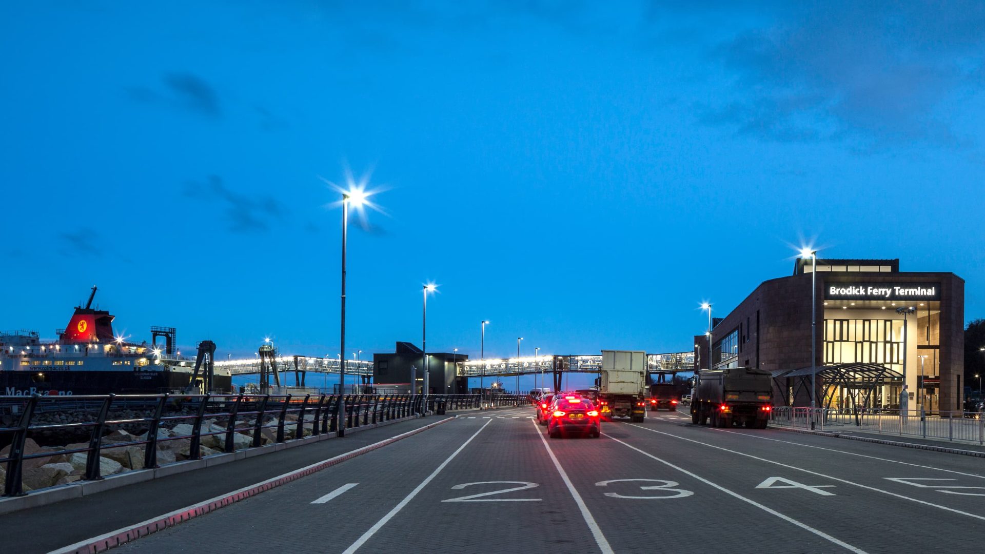 street view of brodick ferry terminal exterior building with cars and trucks