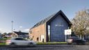 building exterior with cars and road at newmains community trust centre