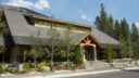 building exterior with trees and driveway at silvertip golf course clubhouse