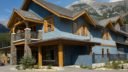 blue building with mountains at silvertip golf course clubhouse