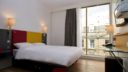 Sleeperz Hotel Room Interior image. view of bed and window view