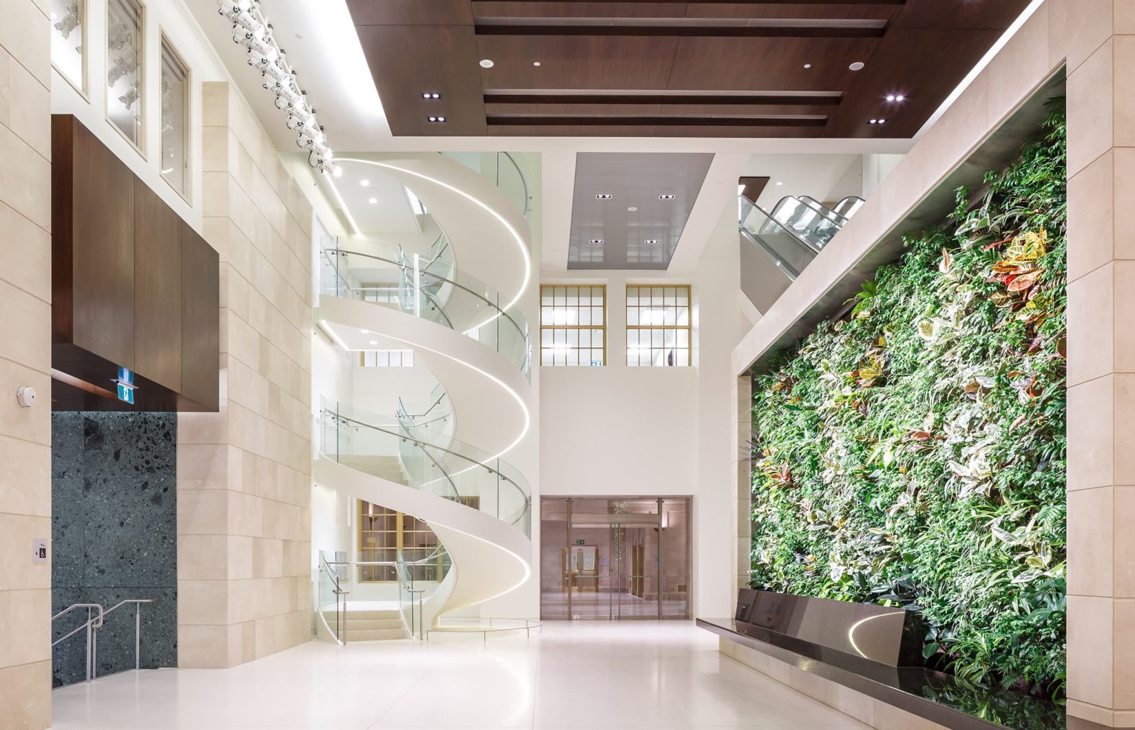 interior of wellington building. green wall to the right and white spiral staircase on the left