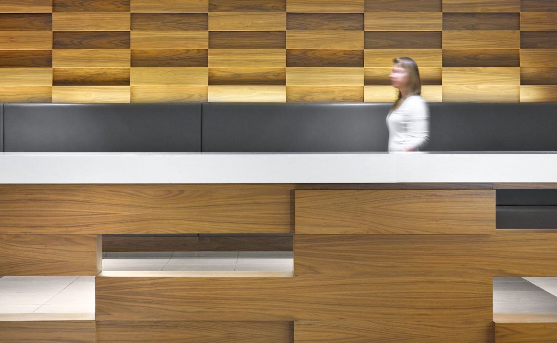 woman walking by wood panelling