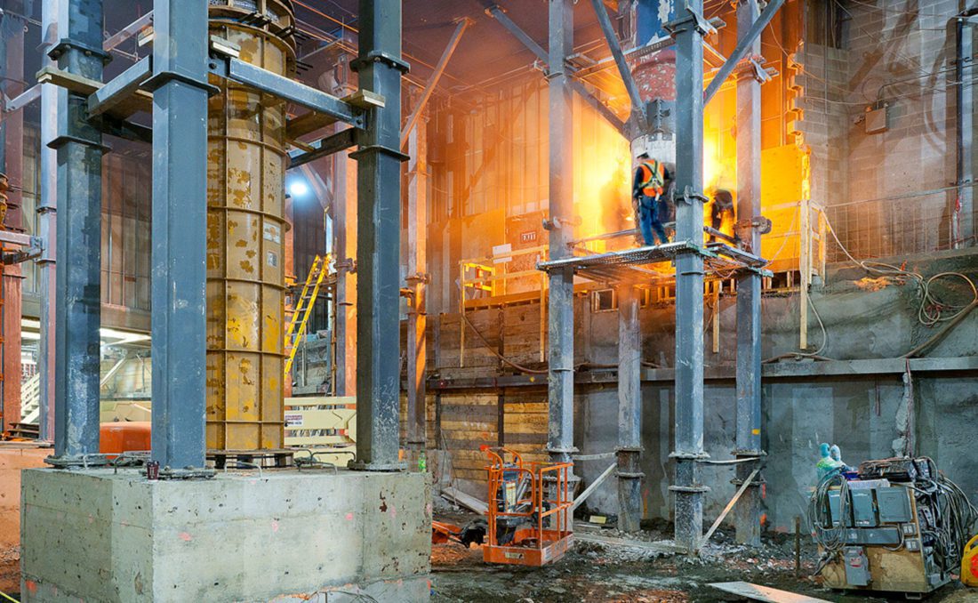 construction site with workers and fire