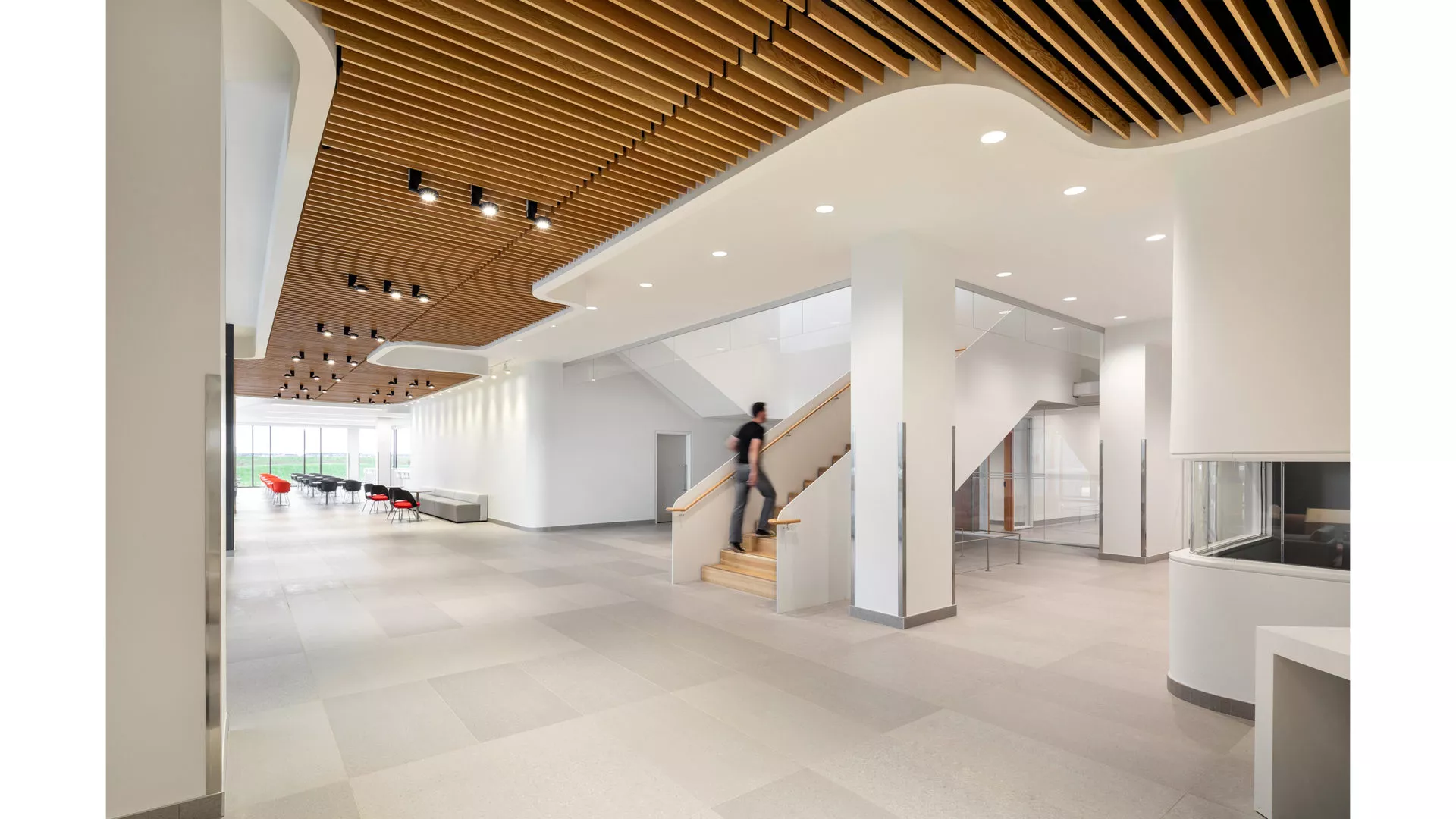interior view of min stairway in cbs calgary. bright white halls with wood panel ceilings