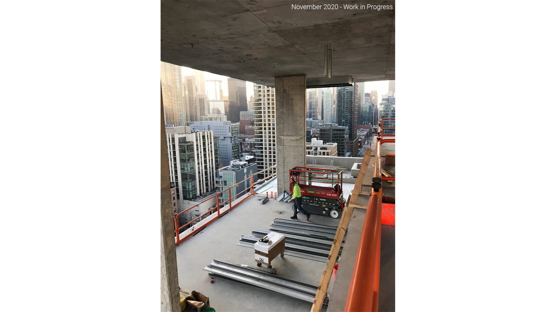 construction image taken from a high rise building. view of city can be seen from the building