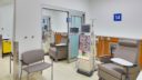 interior of patient room with medical bed, medical equipment and seating