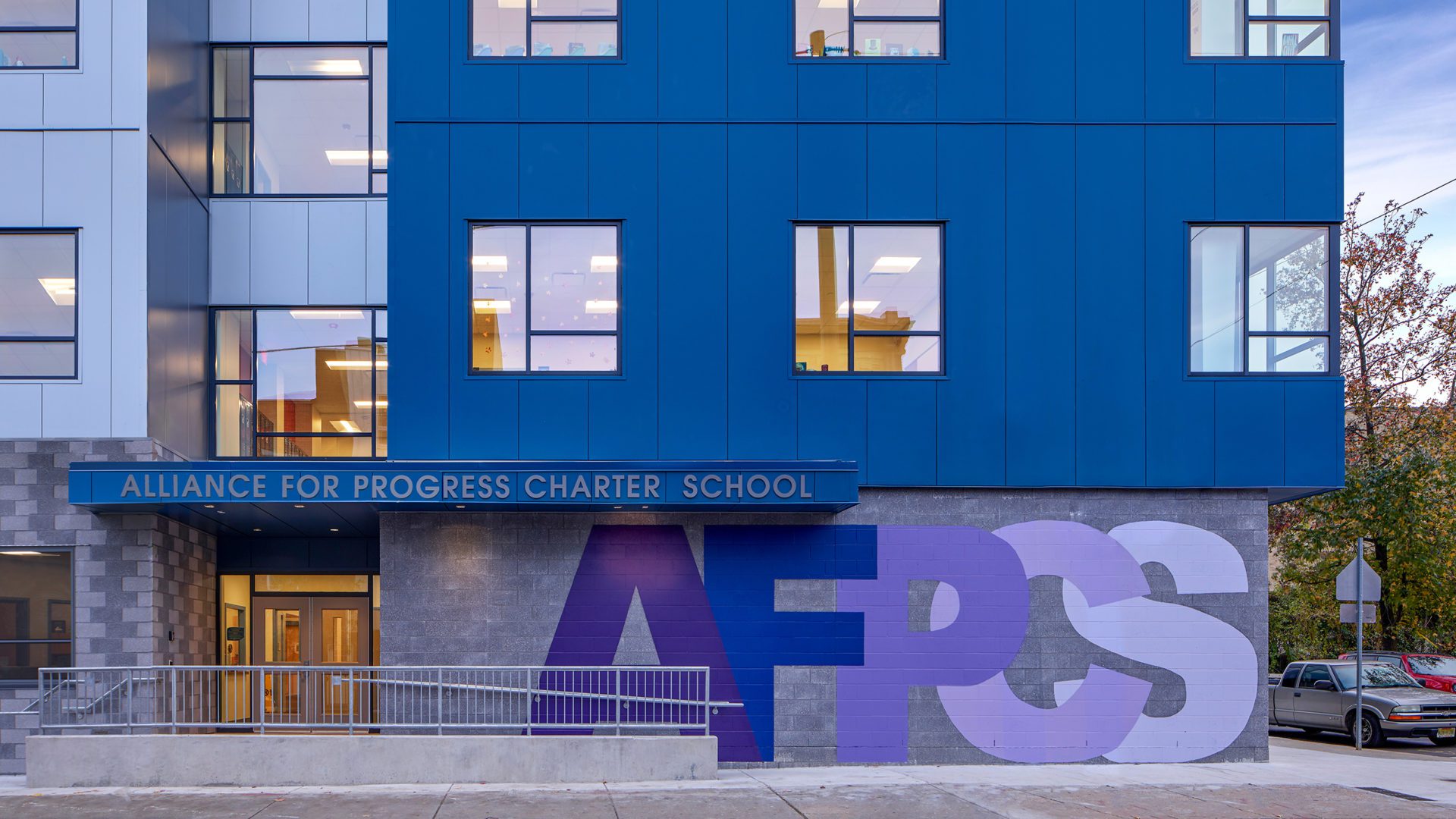 blue and grey school building. sign reads alliance for progress charter school