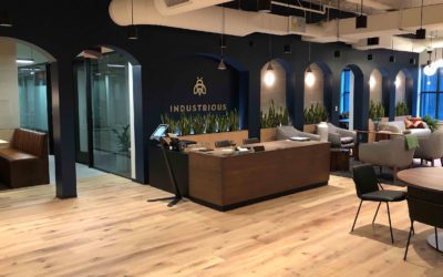 reception area with dark walls and wood desks and tables
