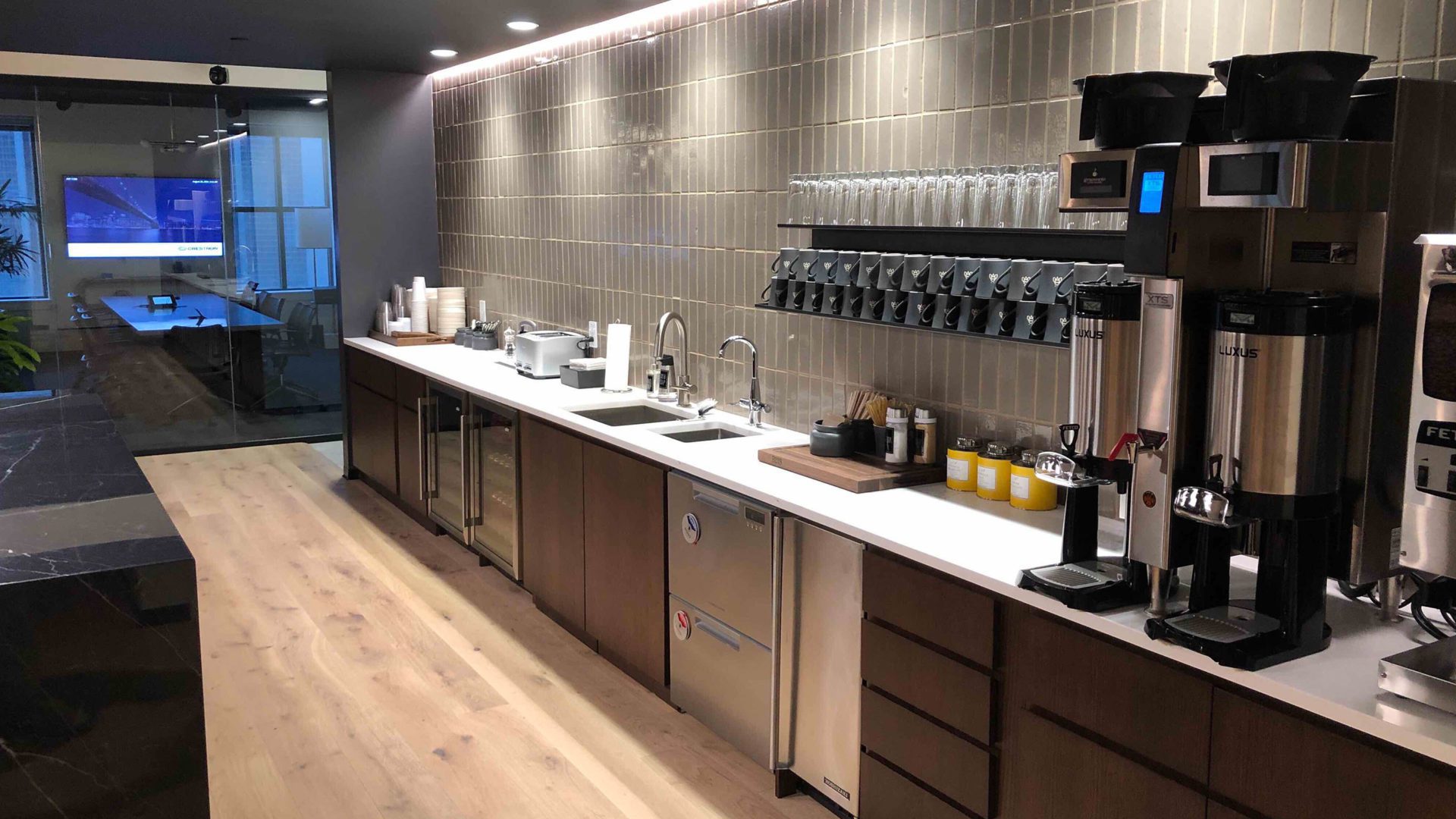 a wall lined with a spacious coffee break counter.