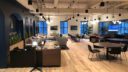 spacious office setting with numerous desks and chairs filling the room