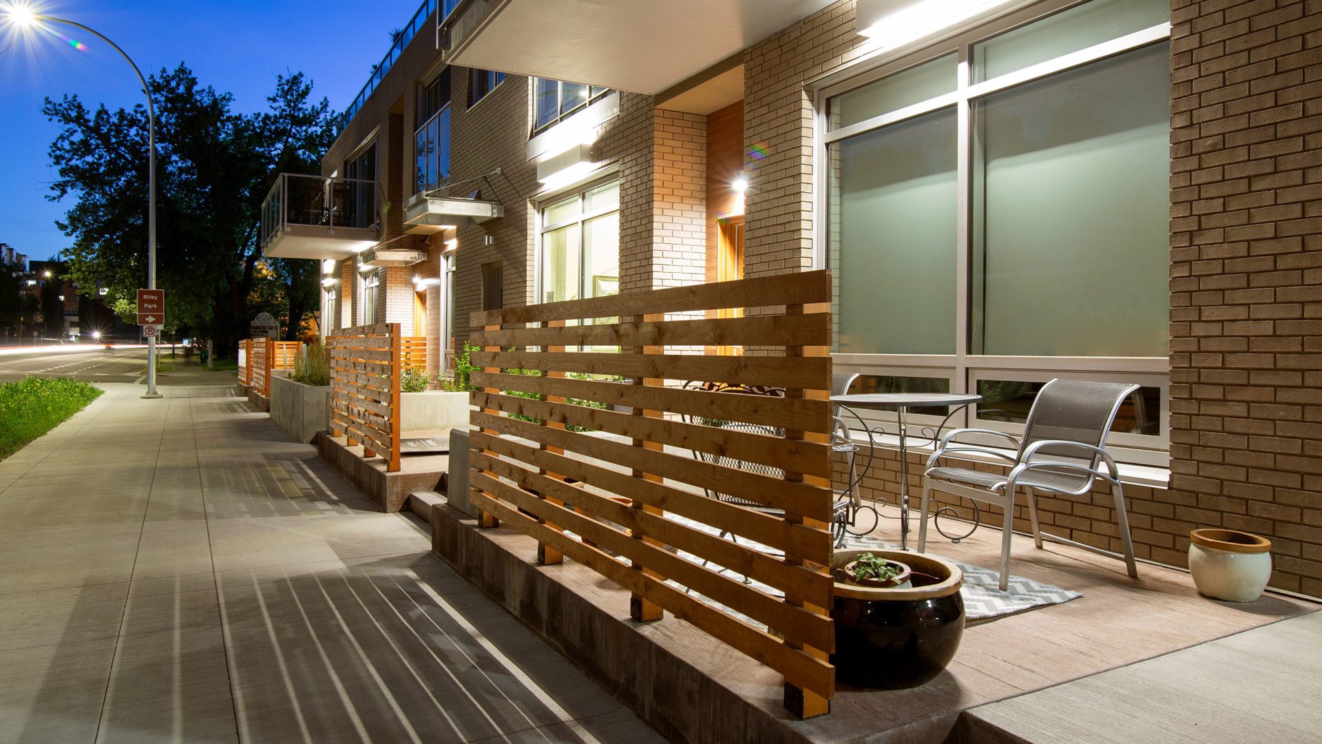 evening view of unit patios at building Ezra on Riley Park