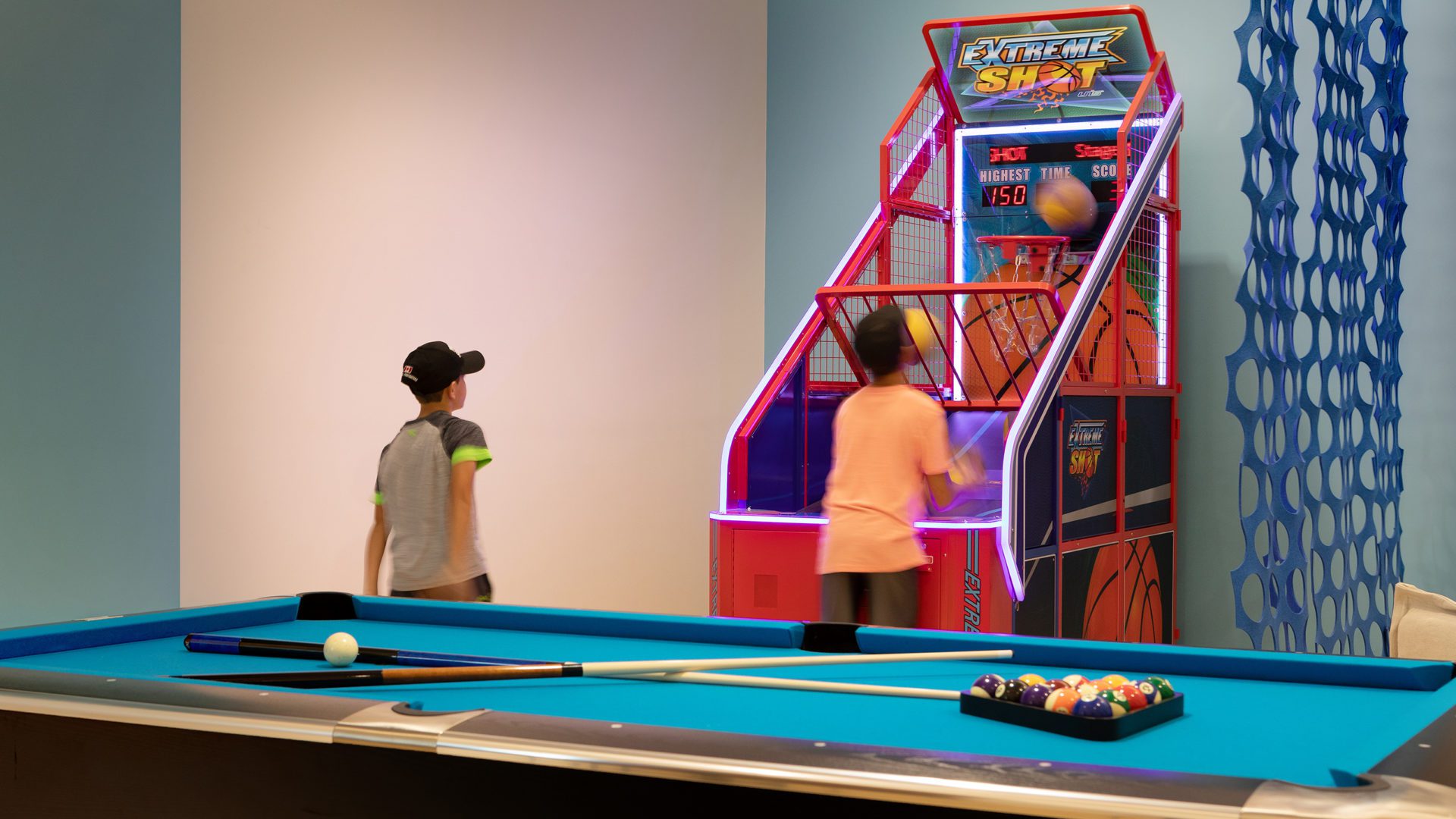 children play "Extreme Shot" in the 10XTO Athletic Club Play Room