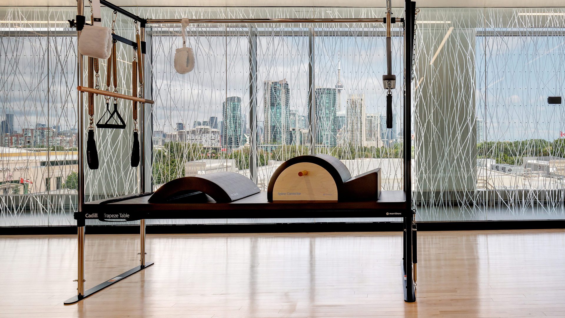 pilates machine and view of city in the background at 10XTO Athletic Club Pilates Studio