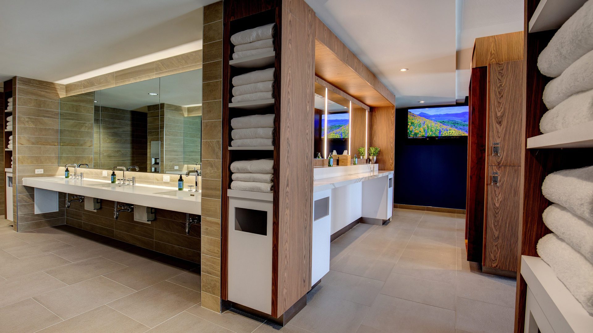 large 10XTO Athletic Club Bathroom with fresh towels in shelves