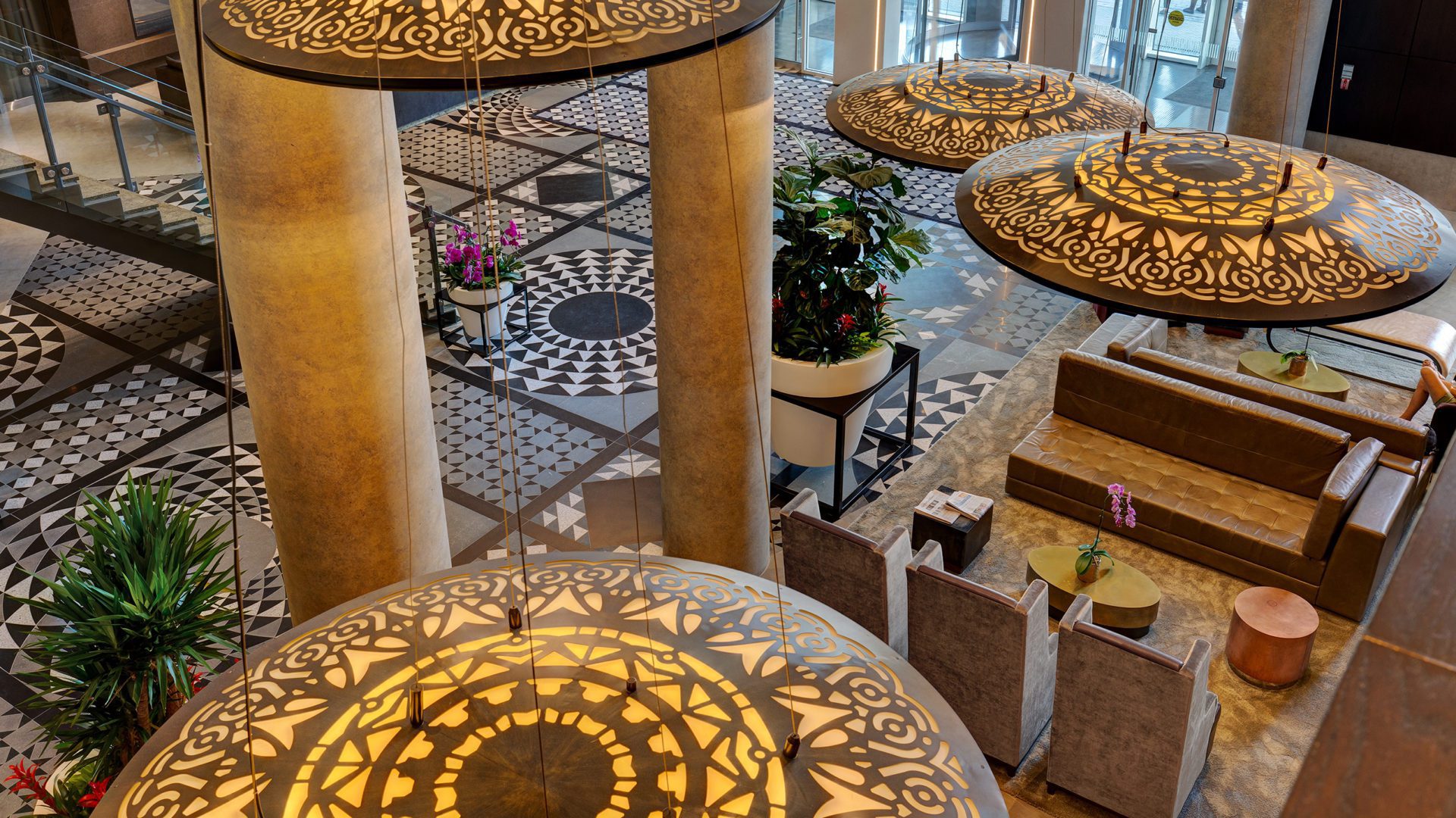 high view of hotel x lobby. large and decorated entrance with tiled floors