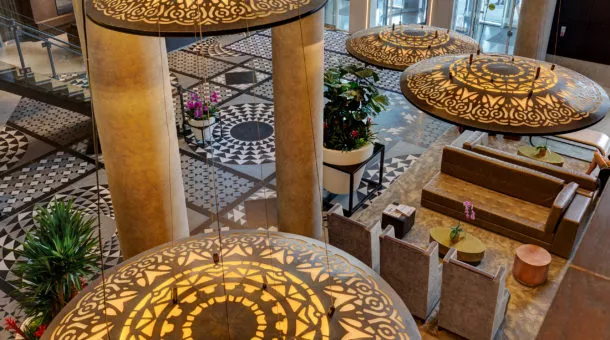 high view of hotel x lobby. large and decorated entrance with tiled floors