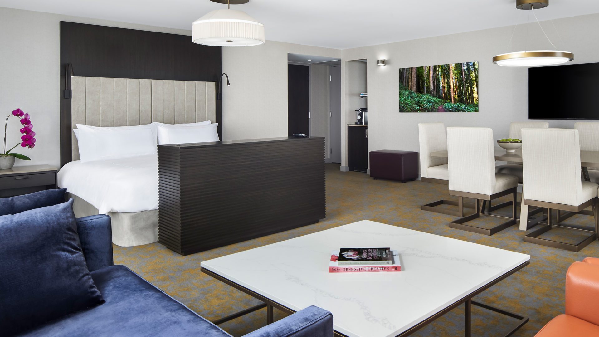 interior view of a Hotel X Suite. comfortable layout includes bed, sitting area and dining area.