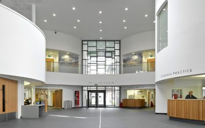 interior lobby and reception view of Vale Health and Care Centre. walls are white. desks and doors are wood