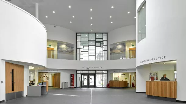 interior lobby and reception view of Vale Health and Care Centre. walls are white. desks and doors are wood