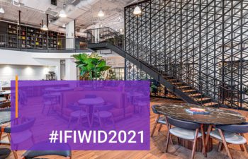 Text reads #IFIWID2021. Background image interior of Industrious Commercial co-working space in Chicago, IL