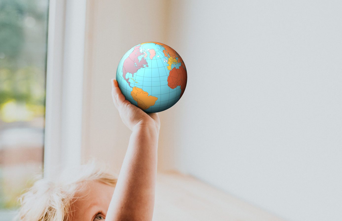 a child holding a small globe