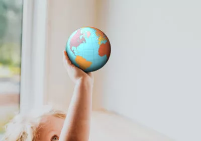 a child holding a small globe