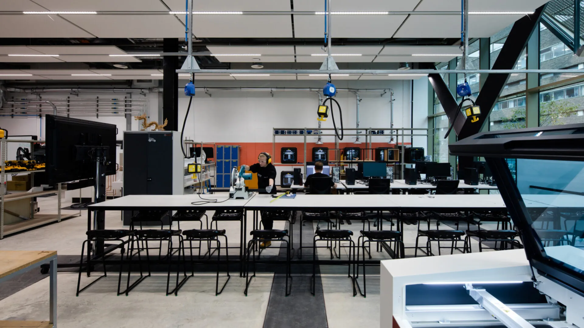 A high-tech workshop with large tables, advanced machinery and equipment.