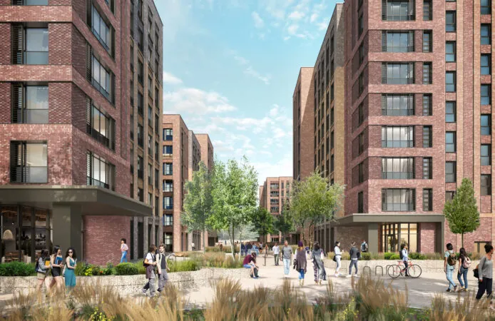 An urban courtyard surrounded by mid-rise brick buildings, with people walking, biking, and sitting among landscaped greenery.