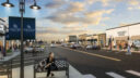 Retail street at Rock Run Collection with storefronts, sidewalks, seating, and crosswalks.