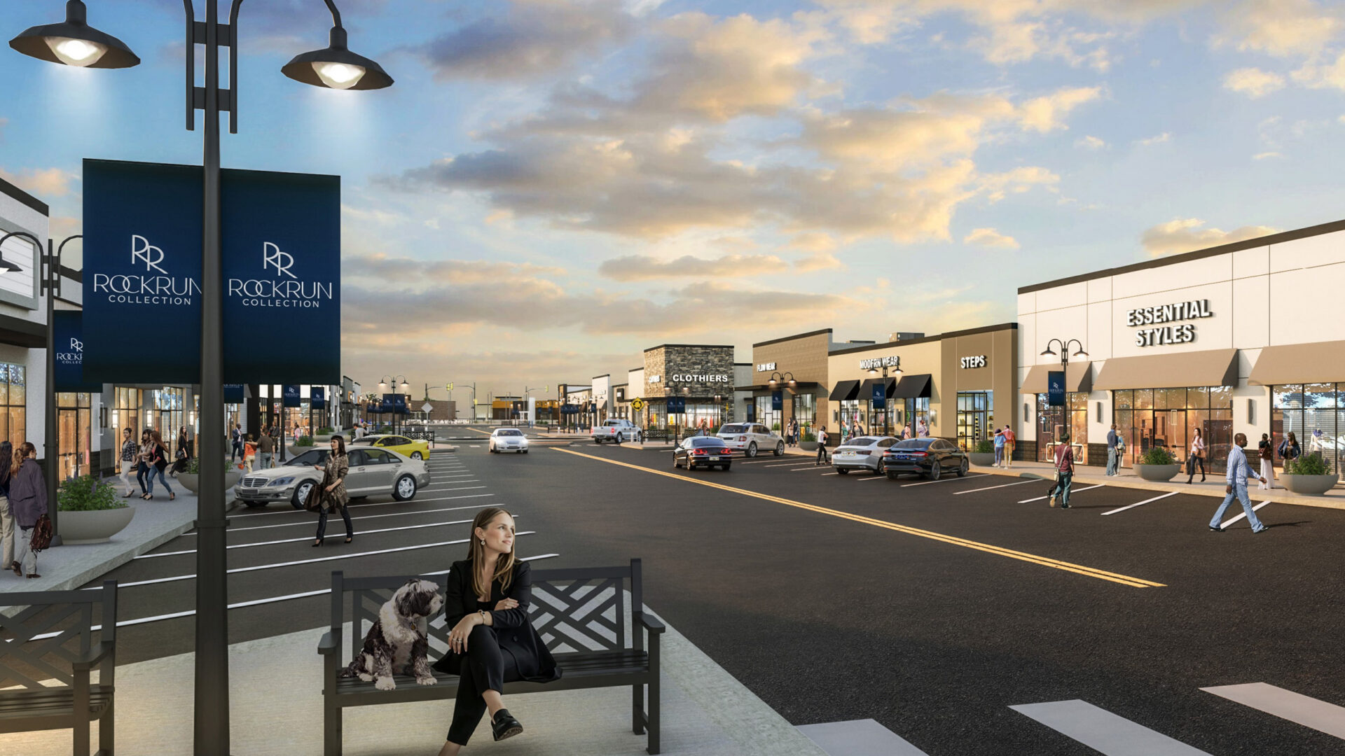 Retail street at Rock Run Collection with storefronts, sidewalks, seating, and crosswalks.